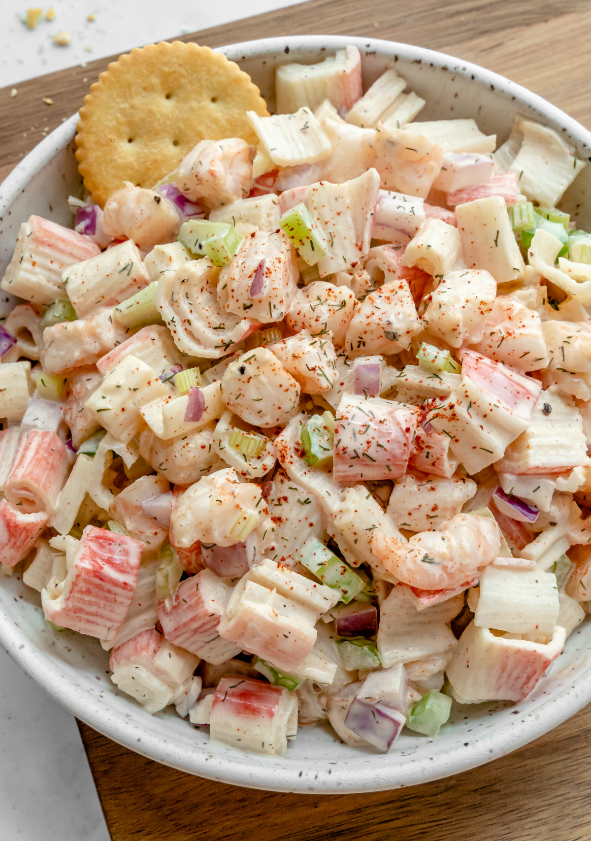 Bowl of Seafood Salad with cracker