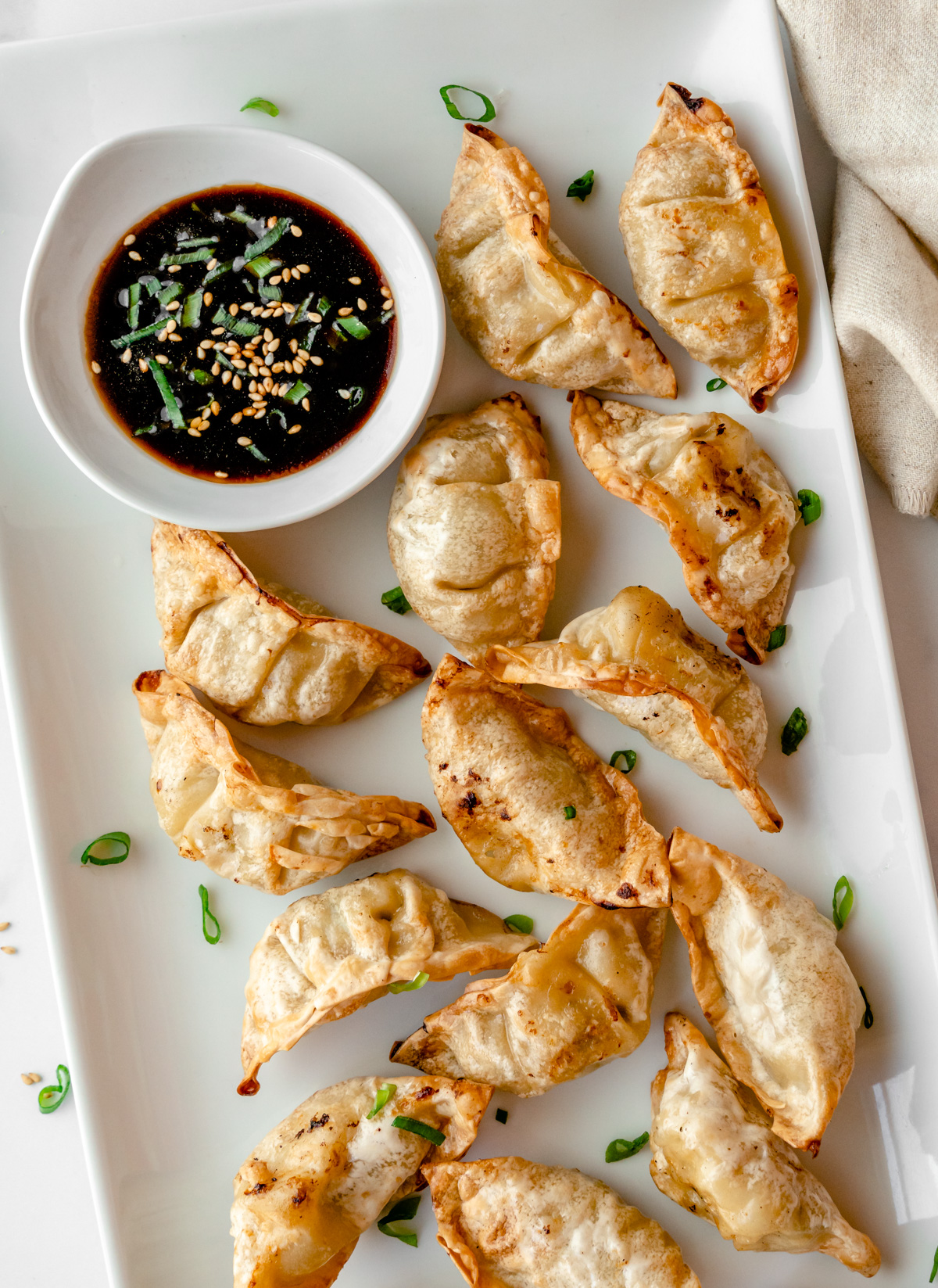 Dumplings with bowl of dipping sauce