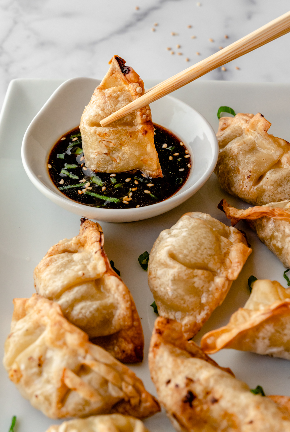 Dipping potstickers into sauce