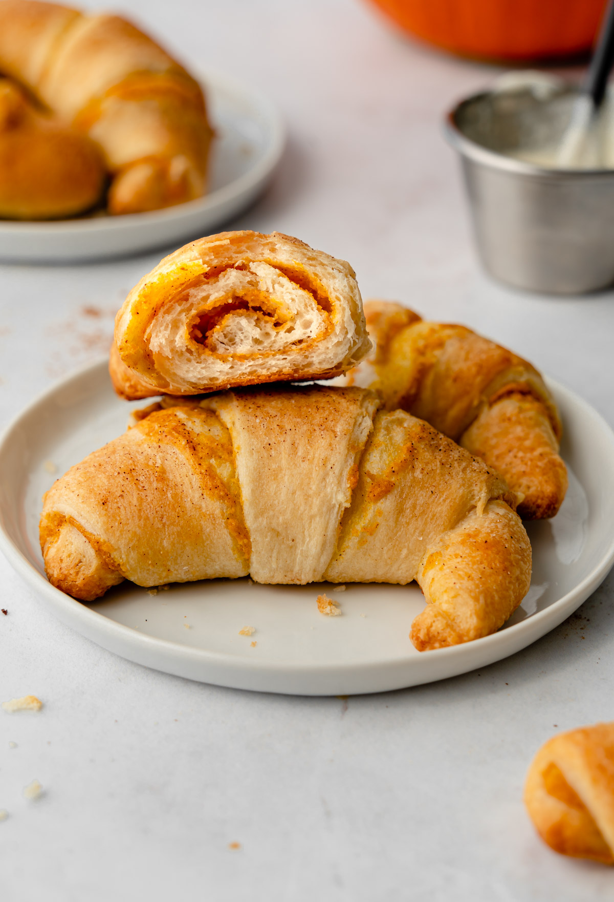Two crescent rolls stacked on each other on a plate