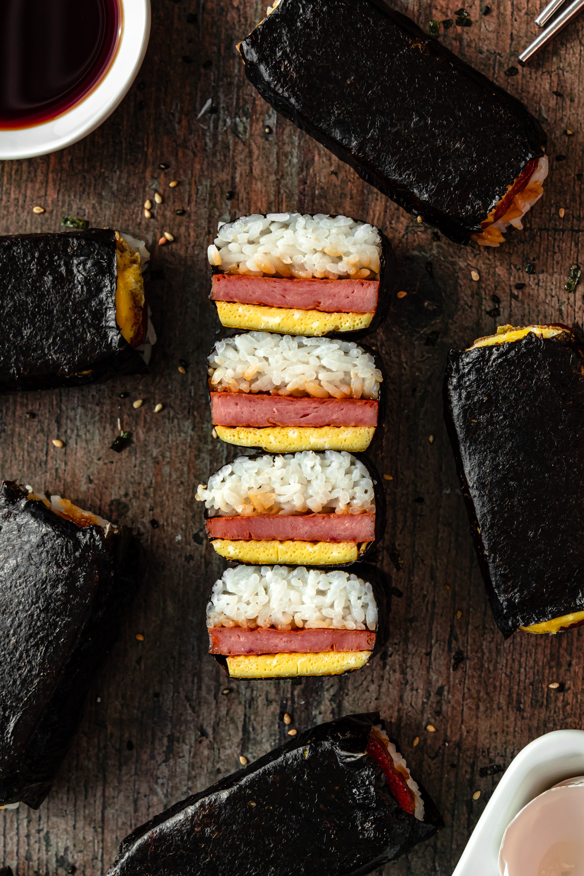 spam and egg musubi cut in half surrounded by musubis.