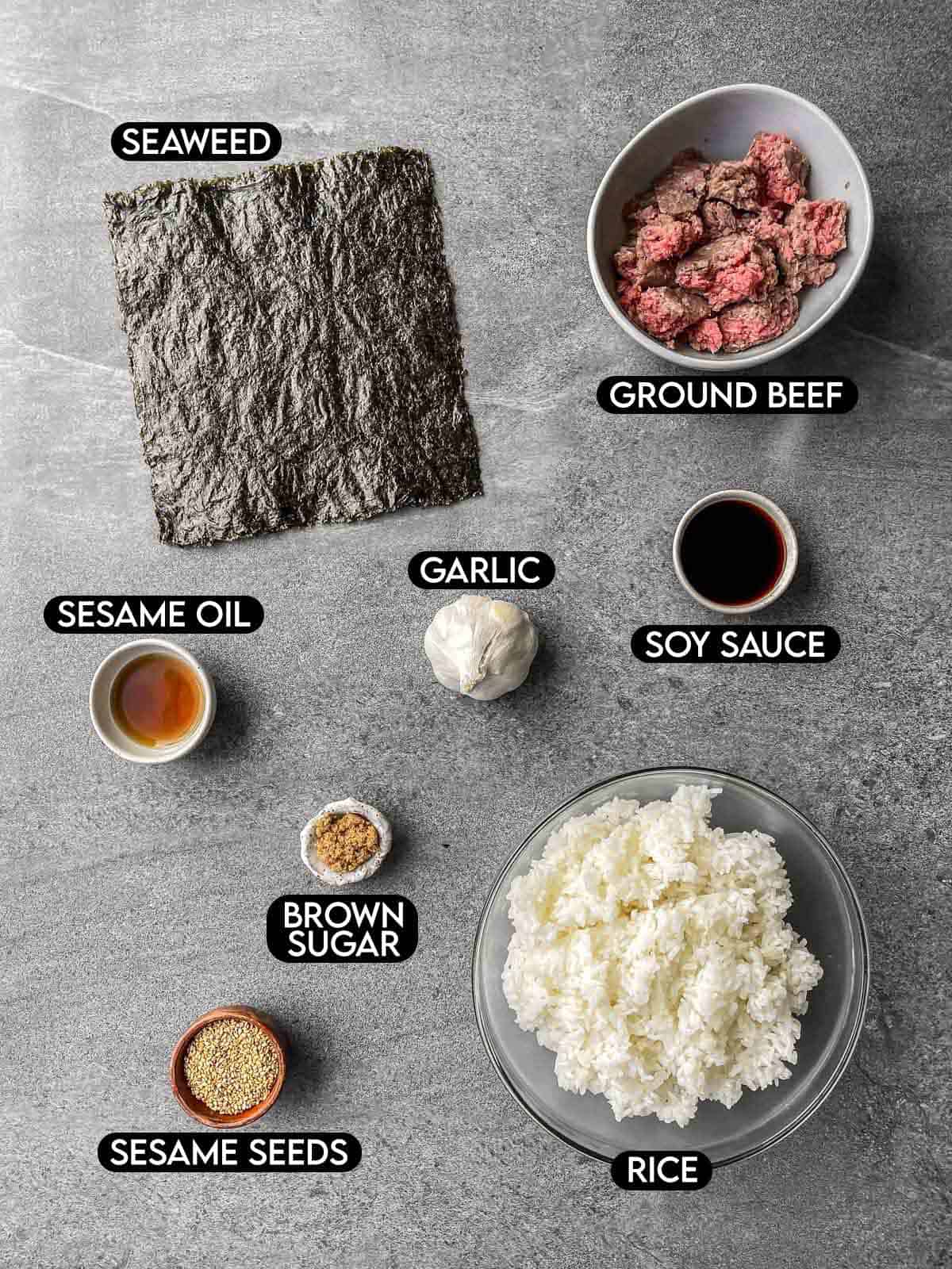 Labeled ingredients for jumeokbap: seaweed, ground beef, sesame oil, garlic, soy sauce, brown sugar, sesame seeds, and rice.
