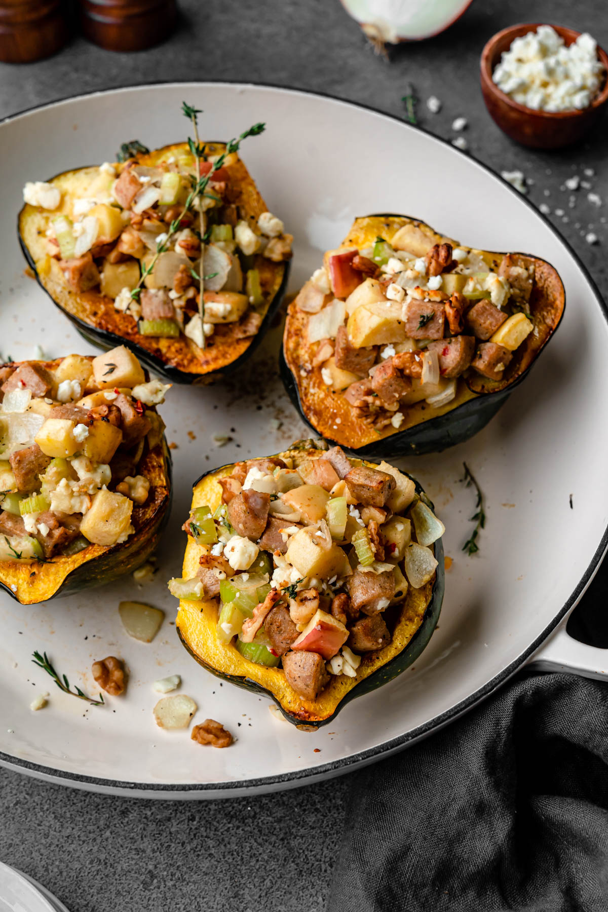 Four Sausage and Apple Stuffed Acorn Squash in a casserole dish.